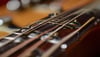 A close-up of a guitar neck with a focus on the st